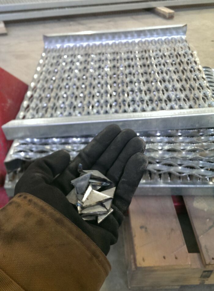 Hand in a glove holding metal shards in front of a metal grate, showing unhinged pics of people doing exactly what they were asked.