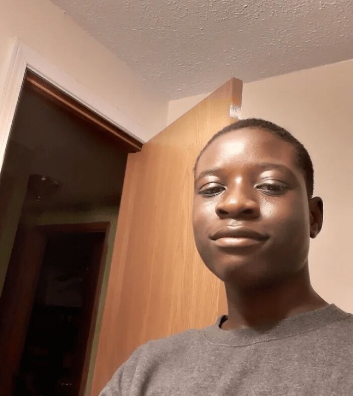 Person taking a selfie indoors with a slight smile, one of the unhinged pics of people doing exactly what they were asked to do