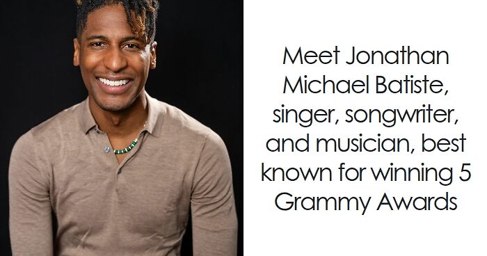 Jon Batiste smiling in a brown shirt, known as a singer, songwriter, and musician with five Grammy Awards.