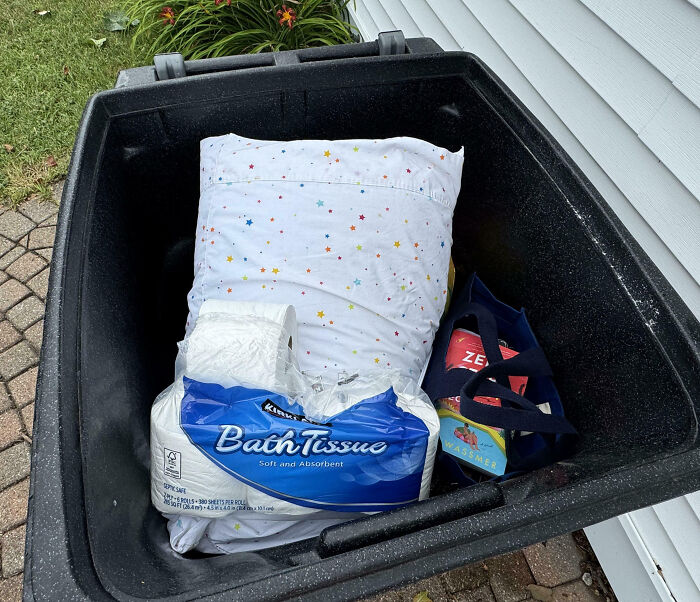 Trash bin filled with pillow, toilet paper, and bags, showing family frustration moments shared online.