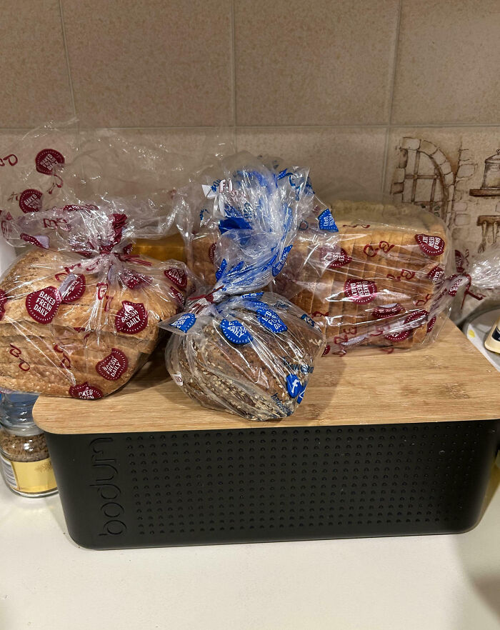 Several loaves of bread placed on top of a wooden and black bakery box, illustrating family frustration moments online.
