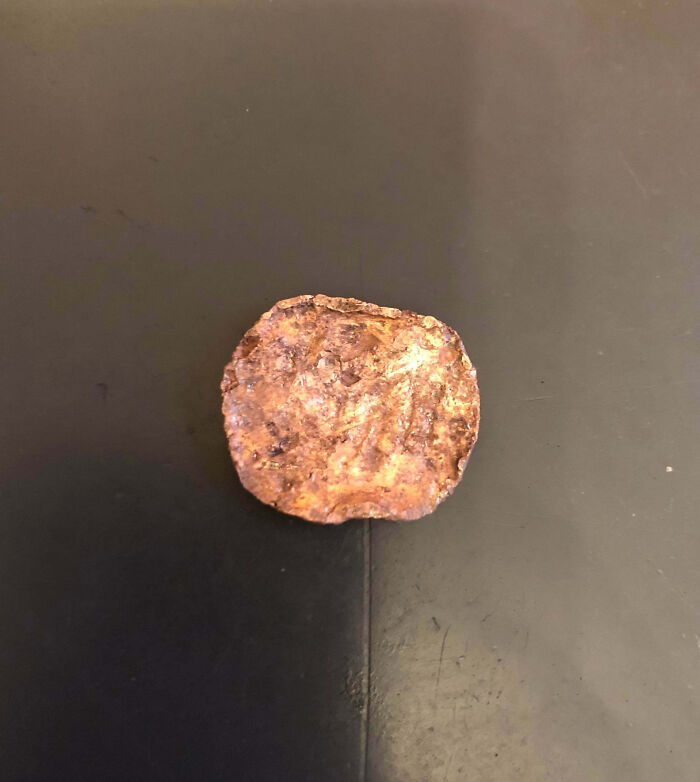 Rusty, corroded coin on a dark surface, illustrating a family member so infuriated they had to vent online.