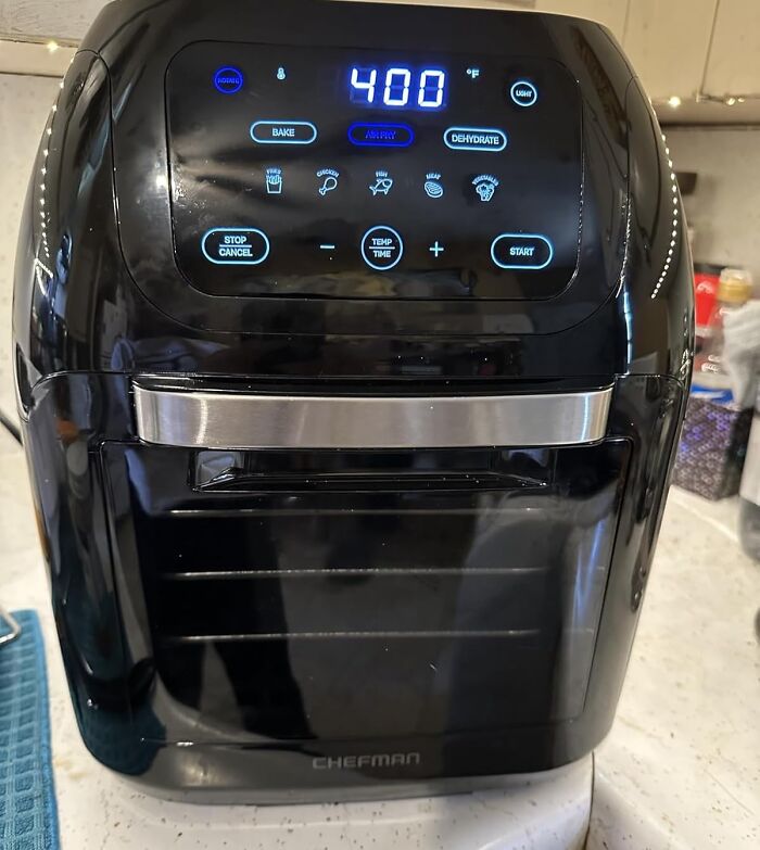 Black Chefman air fryer oven on countertop with digital touchscreen displaying 400 degrees and cooking options, viral product on TikTok.
