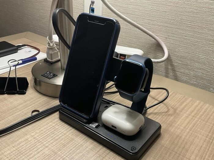 Wireless charging station holding a smartphone, smartwatch, and earbuds, popular viral products on TikTok trending list.