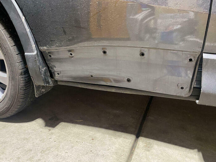 Car door panel missing screws, showing damage likely caused by family members, illustrating frustration shared online.