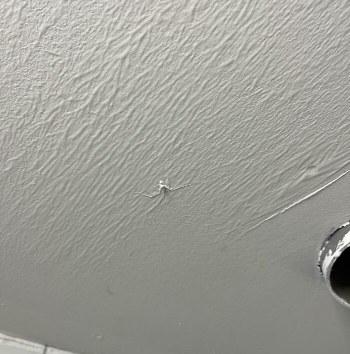 Ceiling with poorly done paint job showing cracks and bubble flaws, illustrating people not even trying in their work.