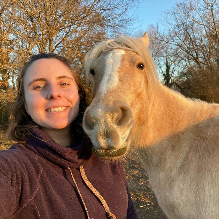 Woman and horse taking a close-up selfie outdoors with natural light, showcasing animals who can take better selfies than you.