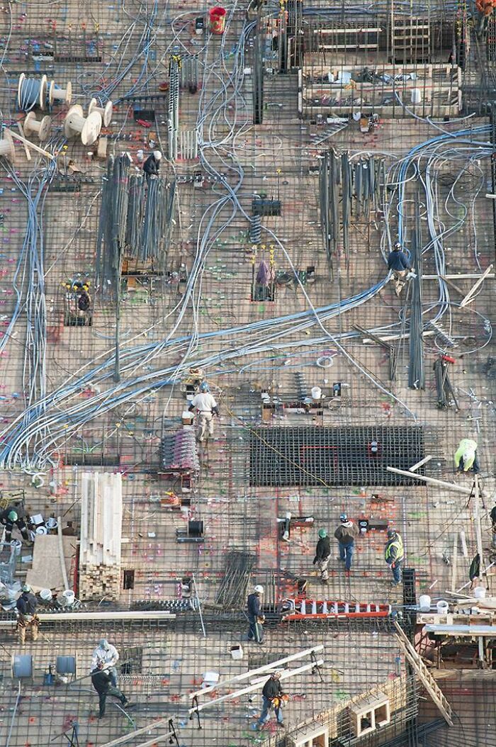 Aerial view of construction site with workers and complex wiring showing our world from a completely different perspective.