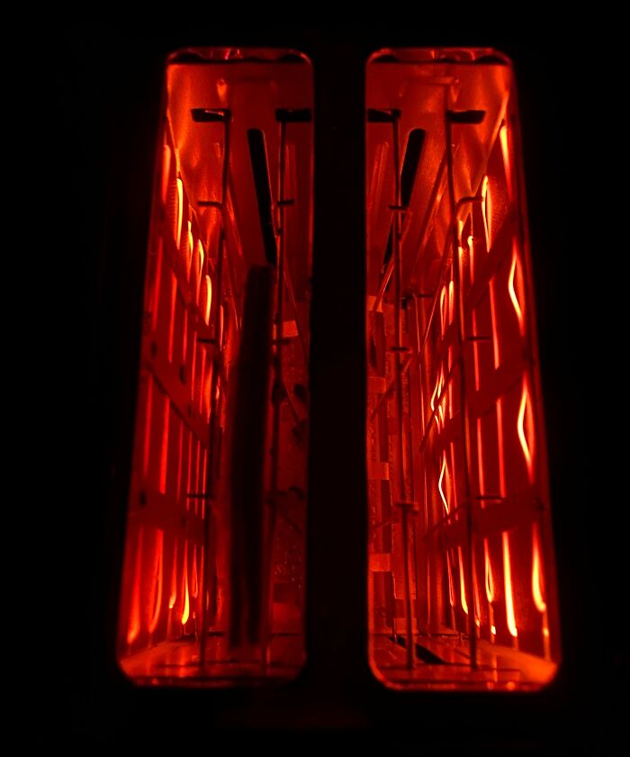 Close-up view of the glowing inside of an object showing intricate heating elements and internal structure details.