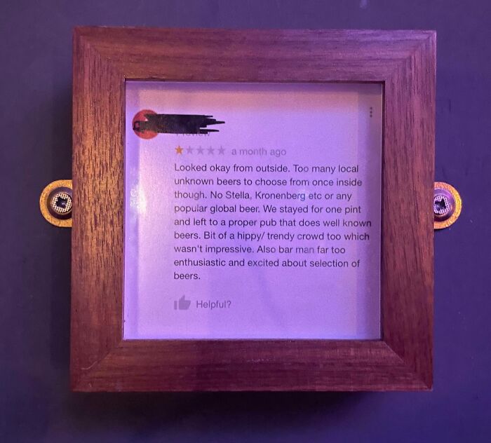 Framed humorous 1-star review criticizing local beer selection and trendy crowd at a pub, showcasing funny ridiculous reviews.