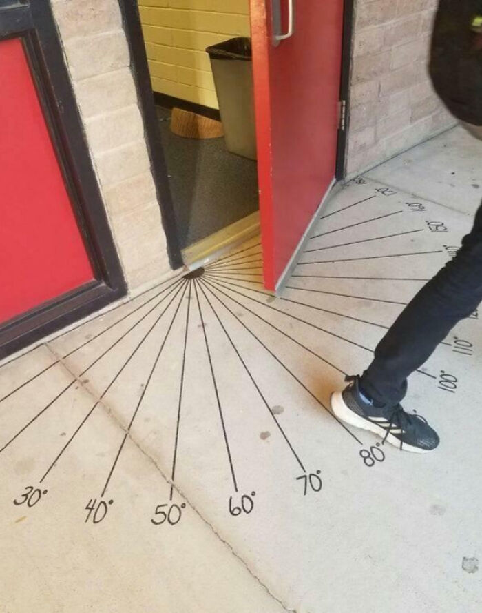 Door blocking an outdoor protractor marked with angles, a funny example of people not even trying at their job.