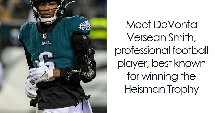 DeVonta Smith in Philadelphia Eagles uniform preparing for a football play during a night game.