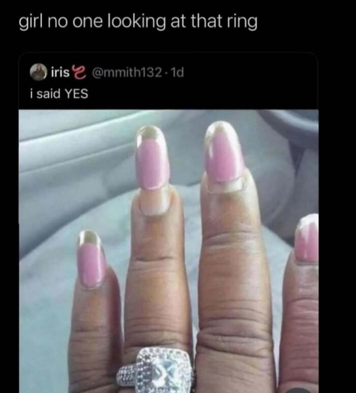 Hand with pink and gold acrylic nails showing a large diamond ring, humorously highlighting makeup and diva life memes.