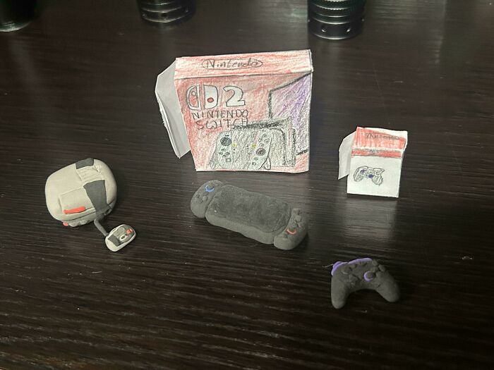 Miniature handmade Nintendo Switch and controllers made from clay and paper, showing sibling gratitude with creative details.
