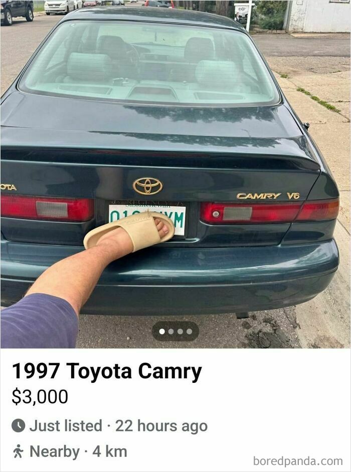 Rear view of 1997 Toyota Camry listed on Facebook Marketplace with a foot playfully covering the license plate.