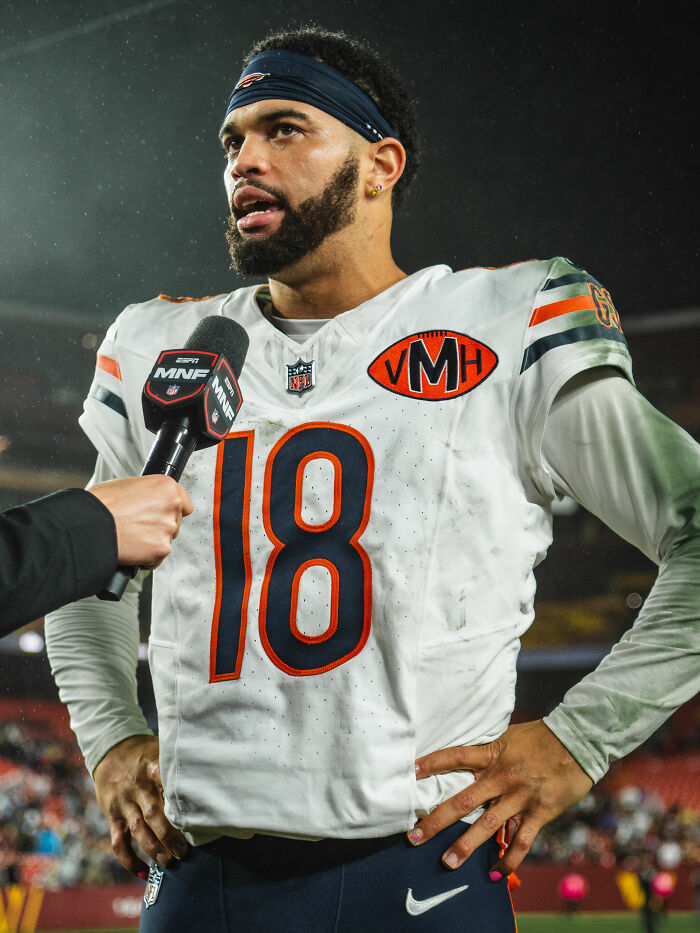 Caleb Williams in football uniform during a post-game interview, highlighting his active career in sports.