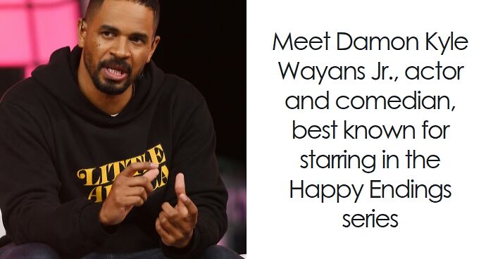 Damon Wayans Jr., actor and comedian, speaking on a stage wearing a black hoodie with yellow lettering.