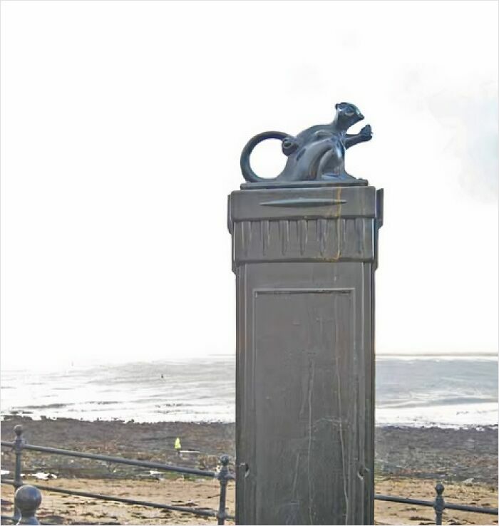 Sculpture of a rodent atop a pedestal by the seaside, representing hilarious historical events that sound made-up.