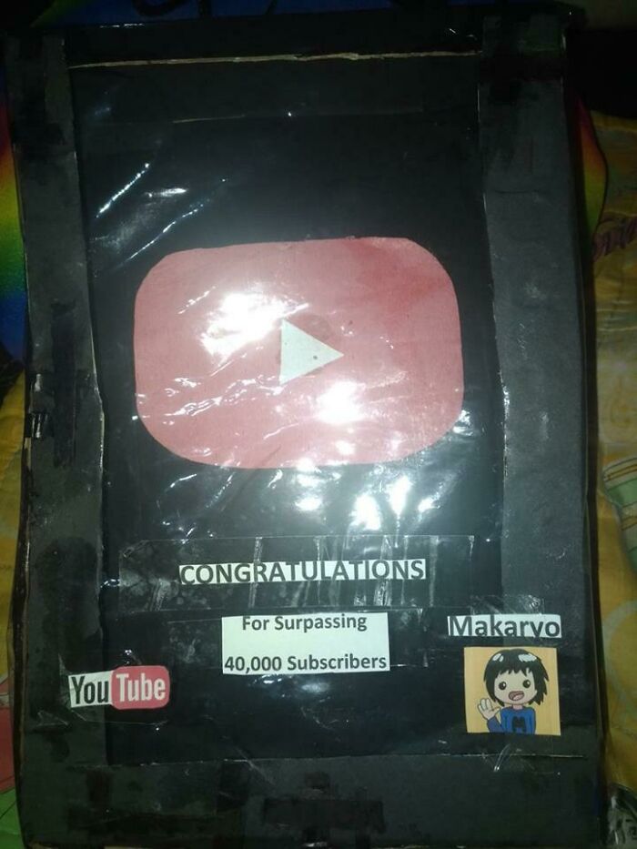 Homemade YouTube play button replica celebrating 40,000 subscribers, showing sibling gratitude and creativity.