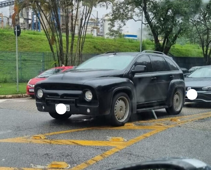 Black SUV modified with unusual vintage car front design as a failed attempt to make a car cooler and unique.