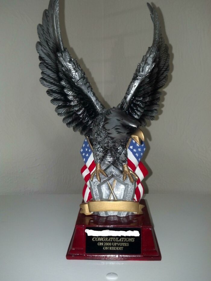 Eagle trophy with American flags and congratulatory plaque, symbolizing Employees who walked out with jokes and pranks.