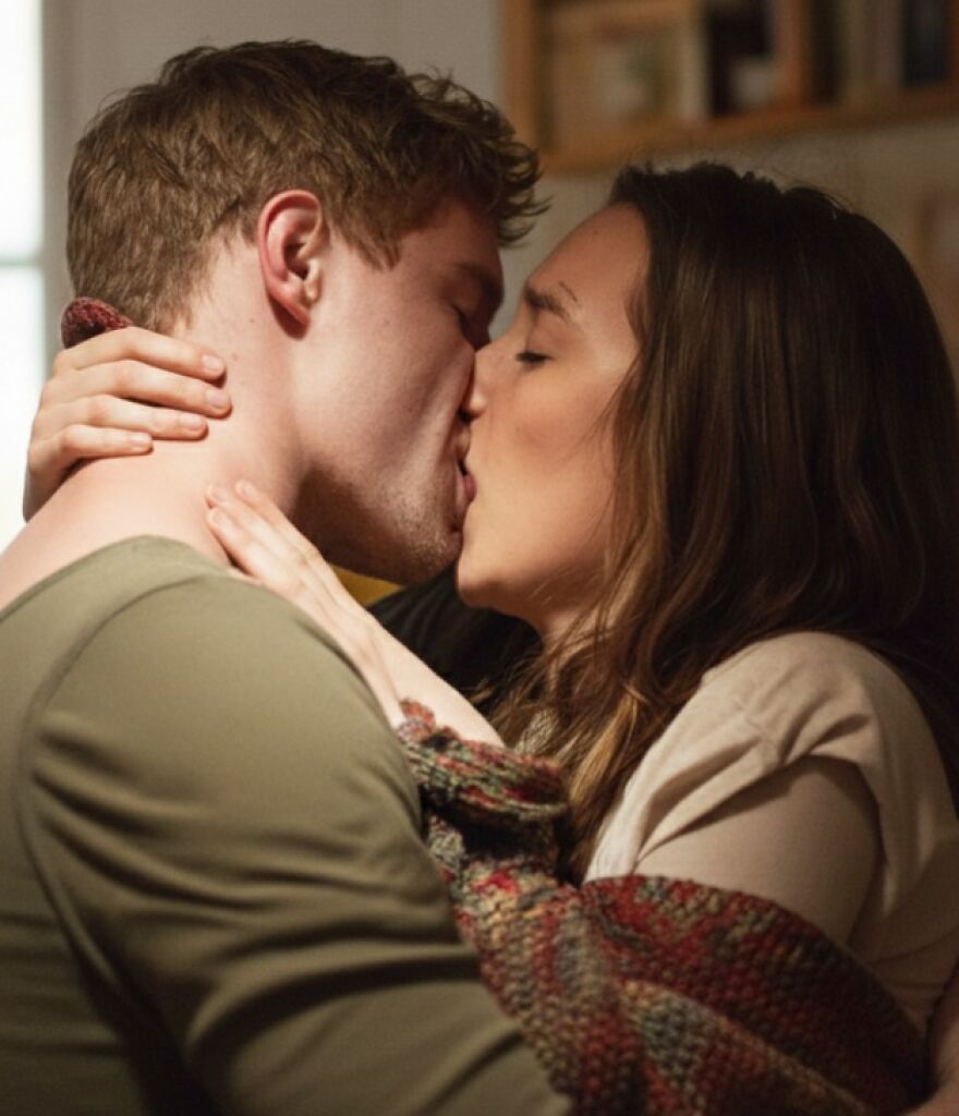 Couple sharing a romantic kiss close-up, illustrating different types of kisses and their cultural significance.