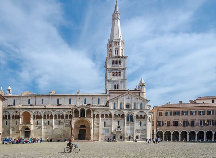 Historic cathedral with tall bell tower under blue sky, illustrating hilarious historical events that sound made-up.