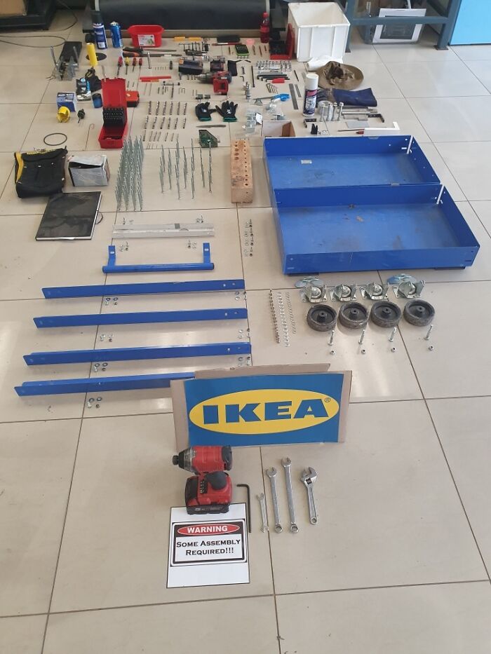 IKEA furniture pieces and tools neatly laid out on the floor as part of employee prank with jokes and zero regrets