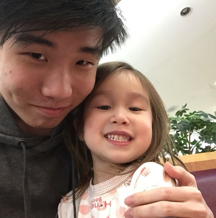 Smiling siblings taking a close-up selfie indoors, showcasing grateful and happy moments between brother and sister.