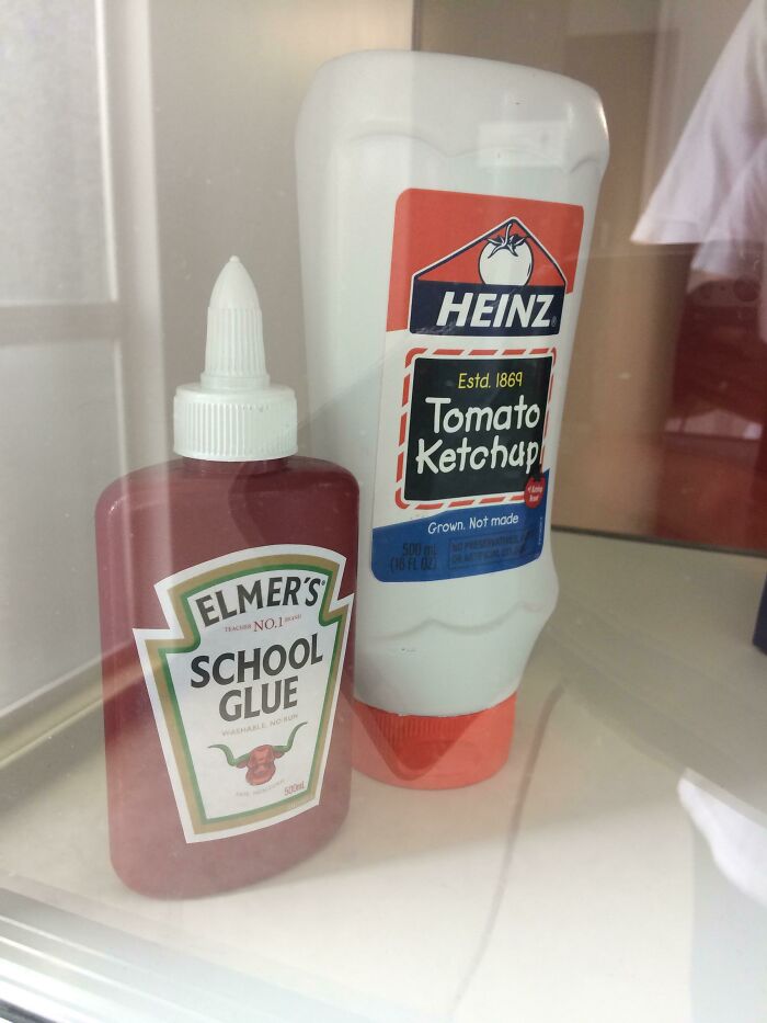 Bottle of Heinz tomato ketchup placed next to Elmer’s school glue, illustrating forbidden foods to avoid eating.