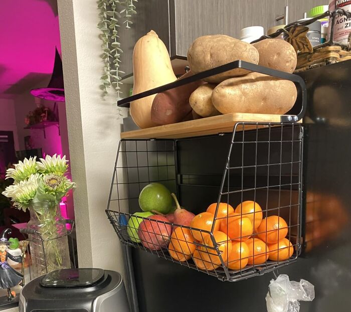 Black Friday kitchen deals with hanging fruit basket and fresh produce organized in a modern kitchen setting.