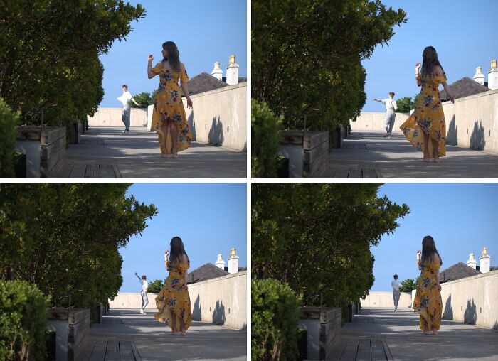 Woman in yellow dress posing while a man photobombs in the background, creating an epic photobomb moment outdoors.