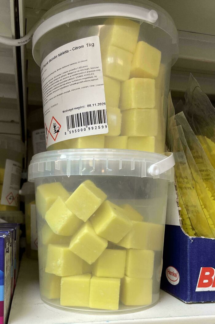 Plastic containers filled with yellow cubes resembling forbidden foods that you should resist eating for health reasons.