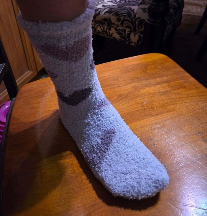 Cozy fuzzy sock on a wooden surface, showcasing comfort and warmth from Alix Earle’s Amazon store Black Friday deals.