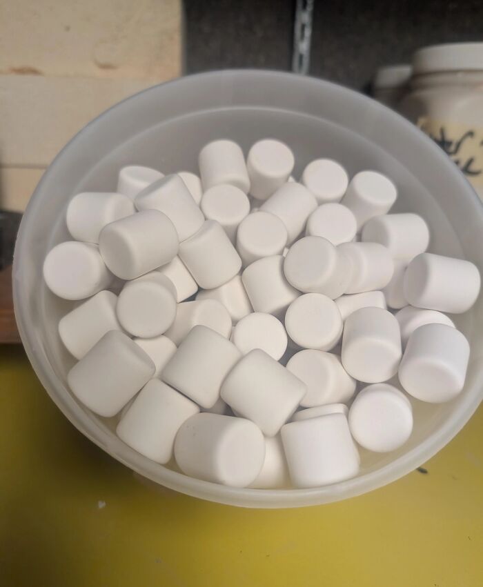 Bowl filled with white cylindrical mints representing forbidden foods to resist for health and wellness.