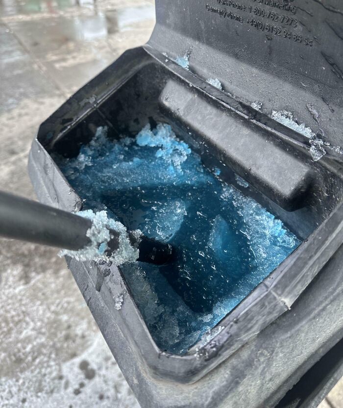 Frozen blue windshield washer fluid inside a car reservoir, illustrating one of the forbidden foods to resist.