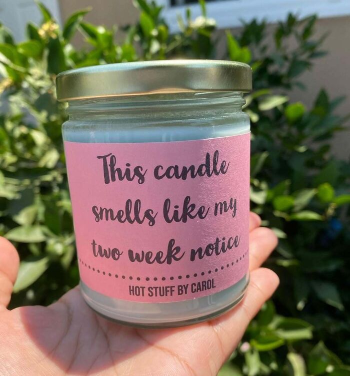 Hand holding a candle with a humorous label related to employees, jokes, and pranks about two week notice.