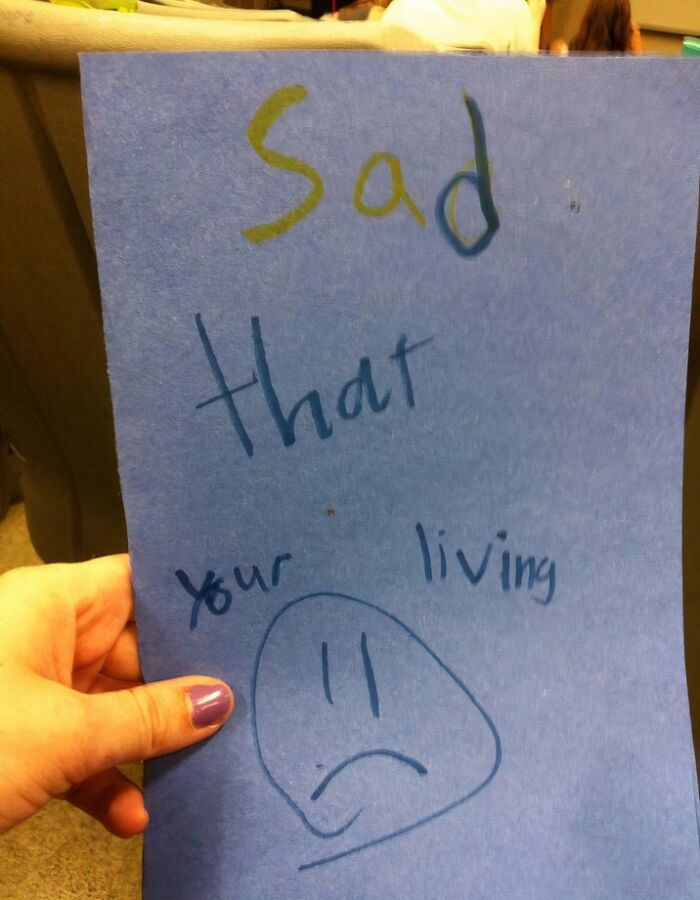 Hand holding a blue paper with a sarcastic joke, part of employees jokes and pranks with zero regrets at work.