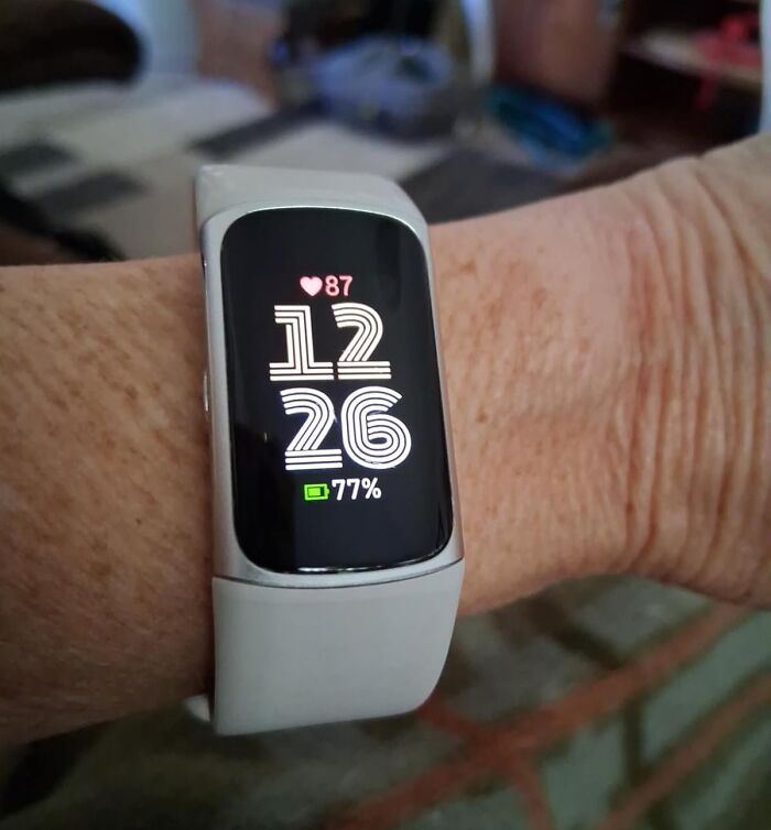 Fitness tracker on wrist showing time heart rate and battery, a perfect Black Friday stocking stuffer deal idea