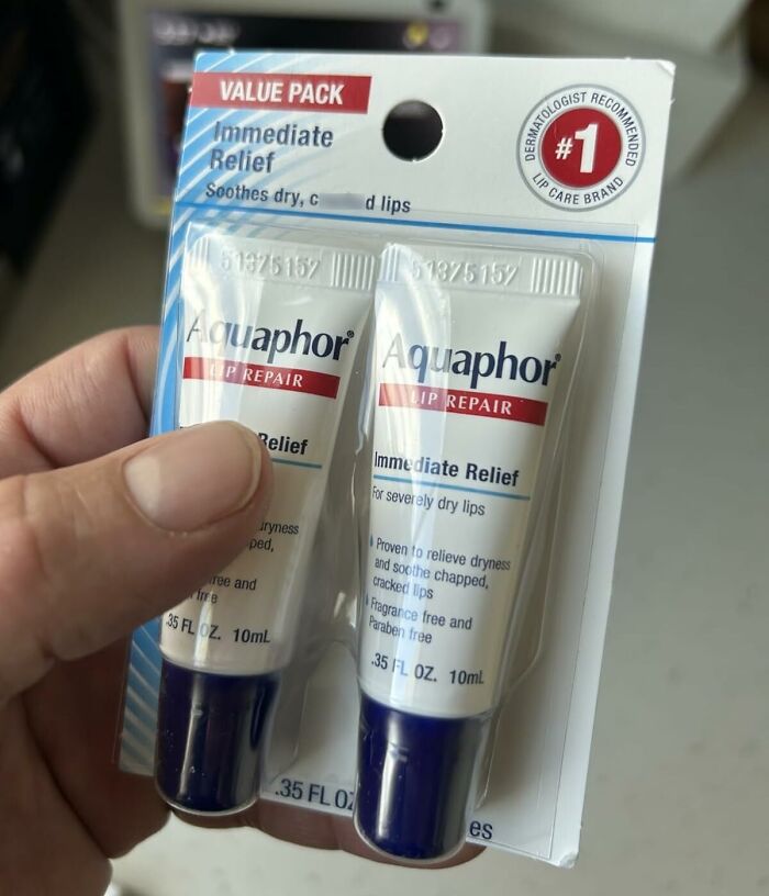 Hand holding Aquaphor lip repair value pack, a popular stocking stuffer for Black Friday deals on gifts.