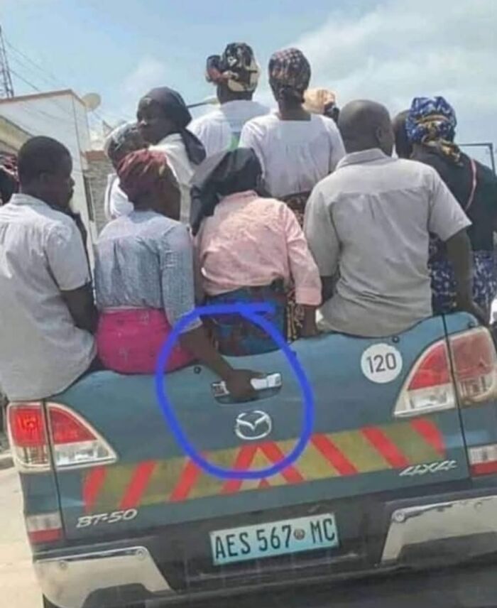 Several people sitting on the back of a crowded pickup truck showing strange and unusual facts of our world.