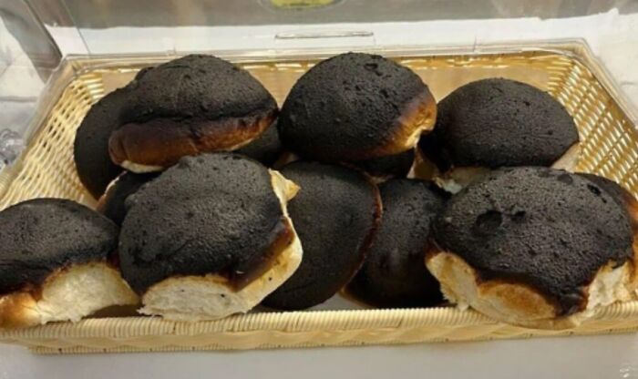 Basket of unusually burnt bread rolls showing strange and unexpected facts about our world.