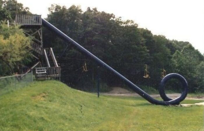 Unusual long slide with a loop in a park, showcasing one of the strange facts and stories about our world.