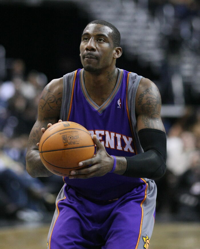 Amar'e Stoudemire in Phoenix Suns uniform preparing to shoot a basketball during a professional game.