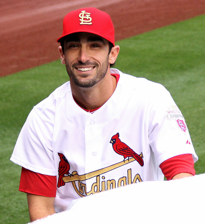 Matt Carpenter in St. Louis Cardinals uniform smiling on the field during a baseball event.