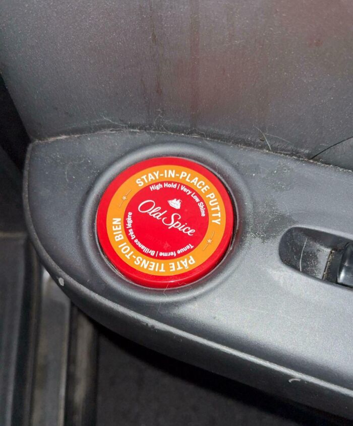 Old Spice stay-in-place putty container perfectly aligned in a car door cup holder showing satisfying precision.
