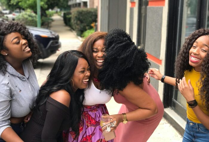 Group of women laughing together outdoors, capturing relatable and ridiculous moments shared among friends.