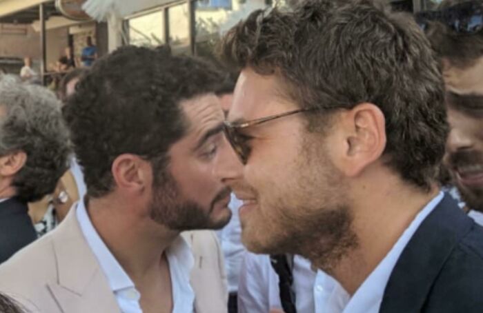 Two men with beards and curly hair standing close, creating a confusing visual effect that challenges the brain’s perception.