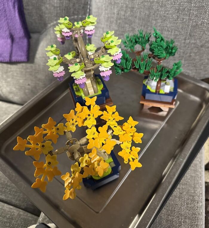 Close-up of colorful Lego tree models displayed on a metal tray, illustrating unique Cyber Monday deals for collectors.