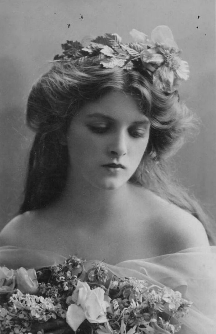 Black and white portrait of a young woman with flowers in her hair, capturing the beauty and diversity of humans.